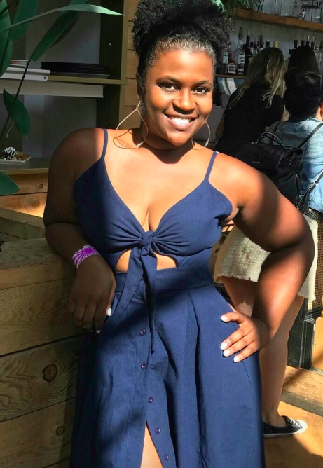 A reviewer wearing a navy dress