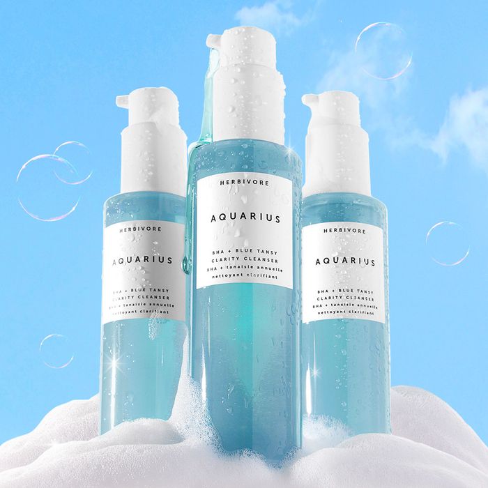 Bottles of Herbivore Aquarius containing a blue cleansing solution.