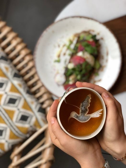 a tea bag designed in the shape of a hummingbird