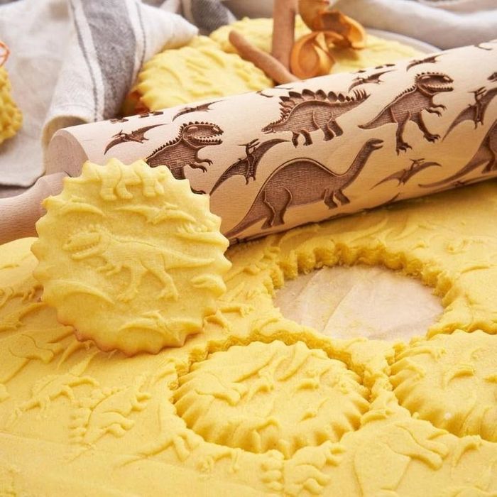 a rolling pin adorned with dinosaur patterns