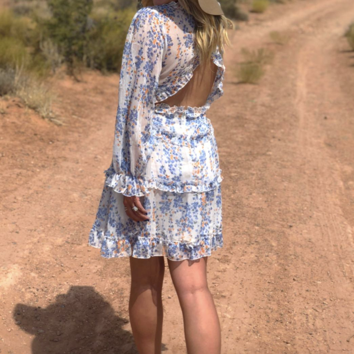 A reviewer showcasing the open-back dress