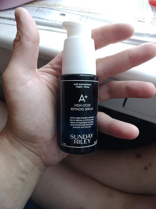A reviewer holding the serum