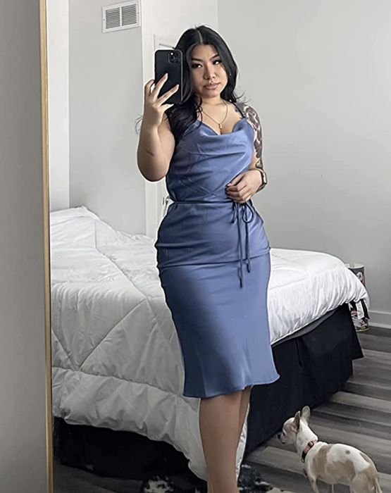 A customer wearing the blue slip dress