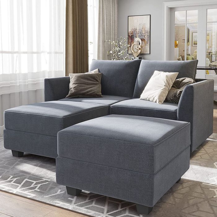 A gray modular sectional sofa is featured