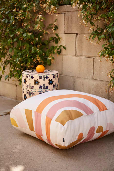 The floor pillow placed in an outdoor setting.