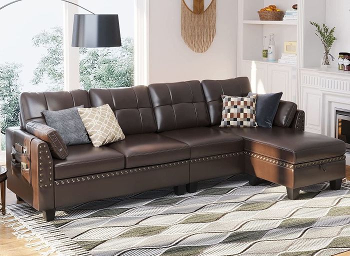 A brown faux leather sofa in a traditional design, displayed in a living room setting