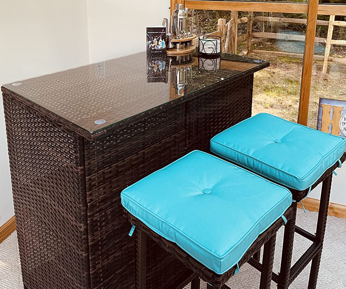 A close-up photo of the bar set featuring blue cushions.