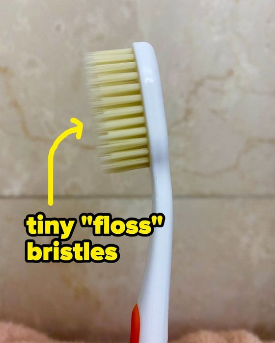 A toothbrush with two layers of bristles: one long and thin, the other short and thick