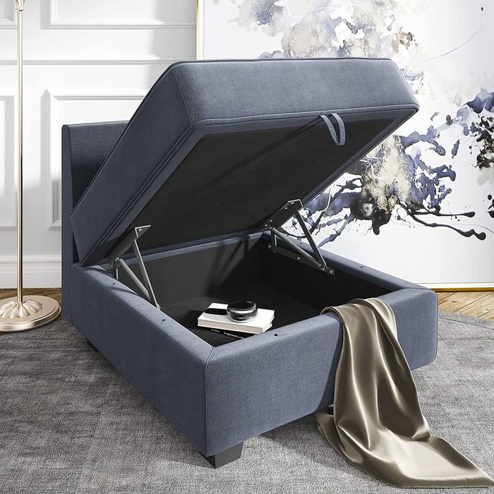 A gray storage ottoman that opens up for extra storage space