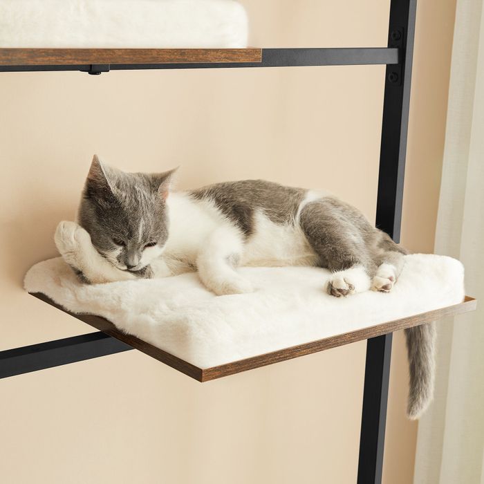 A cat lounging comfortably on one of the cushioned shelves of the multi-level cat tree, soaking in the relaxation.