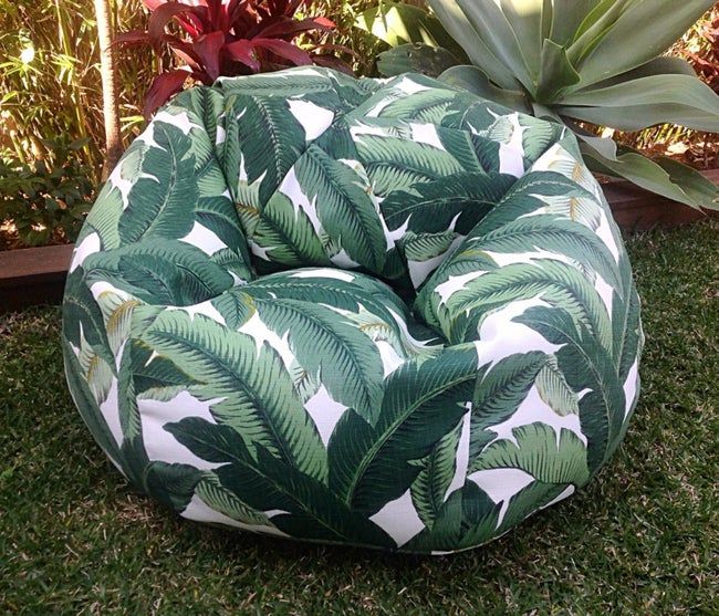 The bean bag featuring a green leaf print pattern.