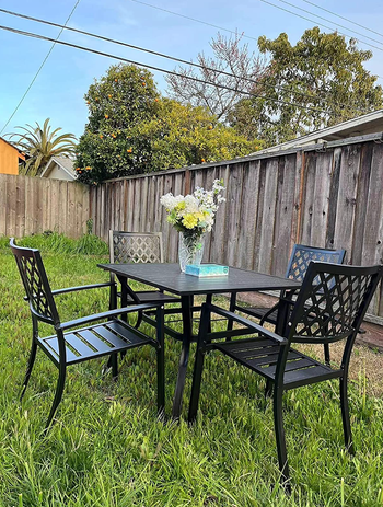 The dining set set up on a grassy lawn.