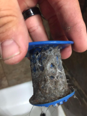 A reviewer’s photo showing pet hair collected by the TubShroom.