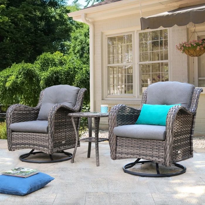 the plush, grey wicker chairs and side table set in a beautifully designed patio space