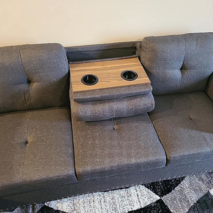 The sectional comes equipped with a convenient drink holder, perfect for keeping beverages close at hand.