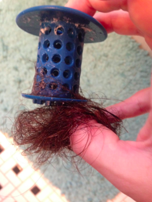 Another reviewer’s image of a large amount of hair gathered on the TubShroom.