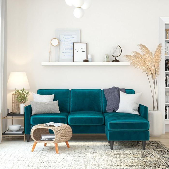 A three-seat teal velvet sectional