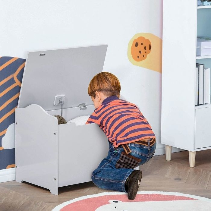 A child happily digging through a toy chest, searching for their next adventure or favorite toy.