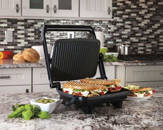 The panini press opens up to reveal a delicious sandwich, ready for your next meal.