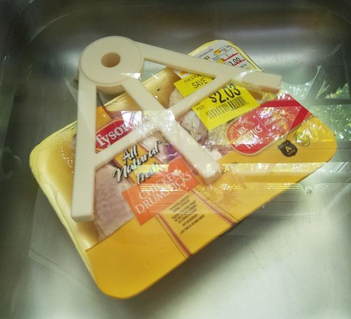 A reviewer's photo showing the thaw claw used to defrost chicken