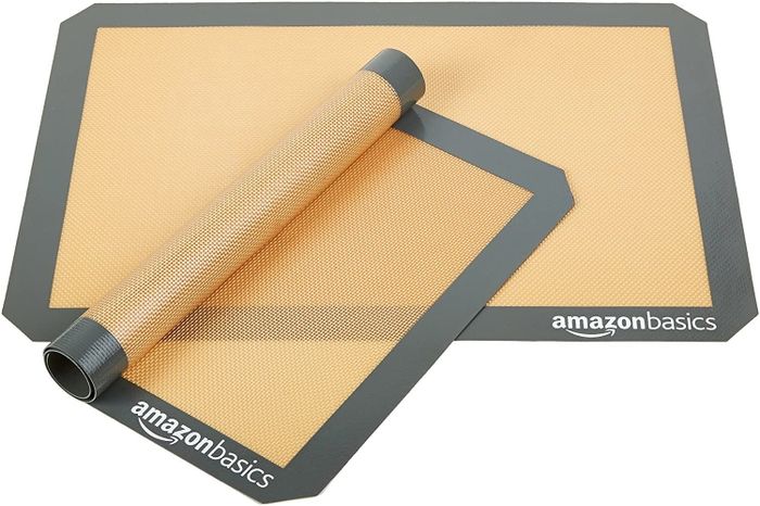 Two flexible silicone mats, one rolled up to highlight its bendability