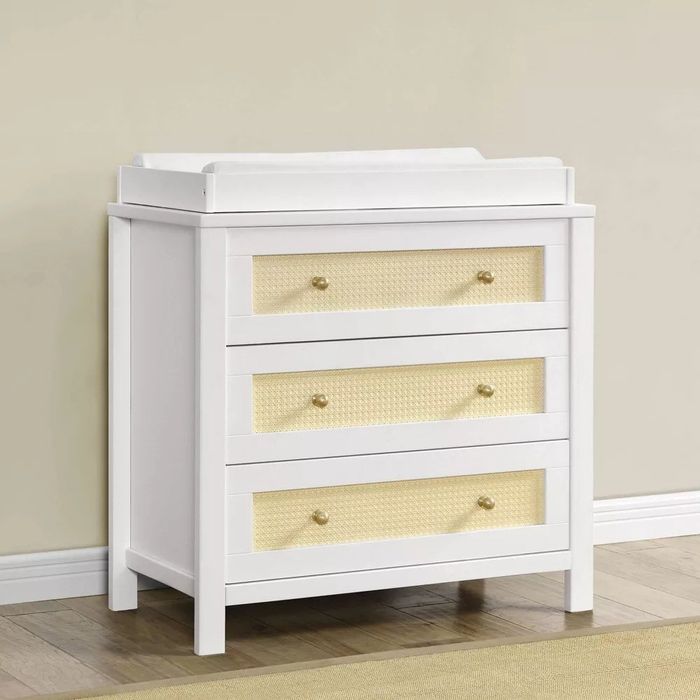 A white changing table paired with a matching dresser.