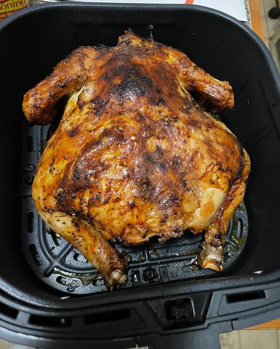 a whole chicken prepared in the air fryer by a reviewer