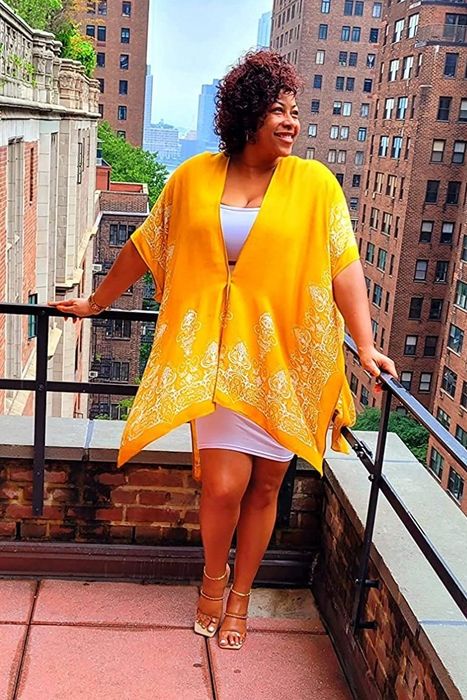 A reviewer wearing the coverup in vibrant yellow.