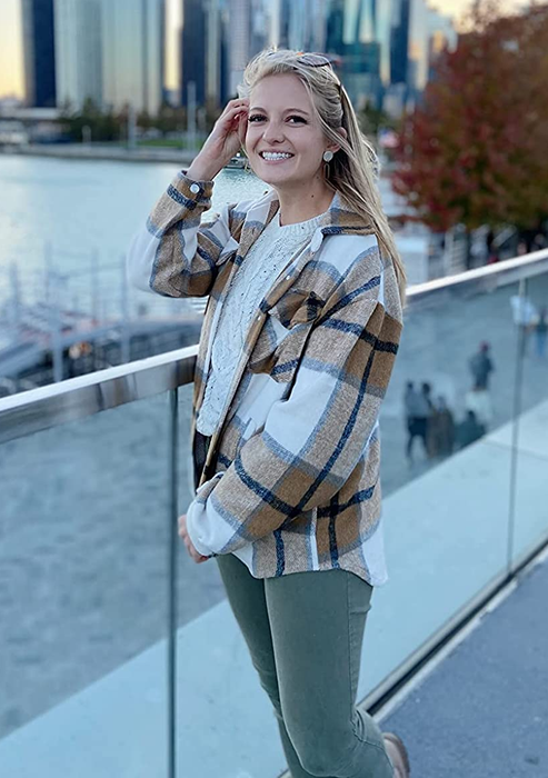 A reviewer showing off the shacket in beige.