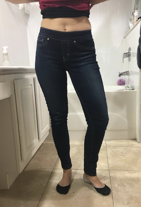A reviewer in medium-wash denim skinny jeans