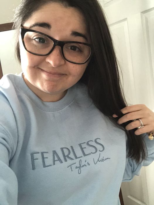 Mytour editor rocking a light blue crewneck featuring the words