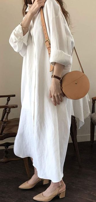 A model is pictured wearing the white version of the dress.