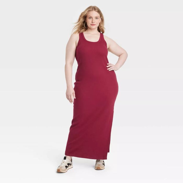 A model dressed in a maroon dress.