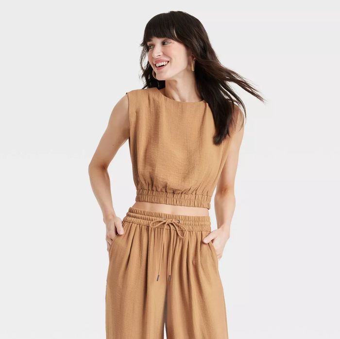 A model wearing a tan top paired with matching pants.