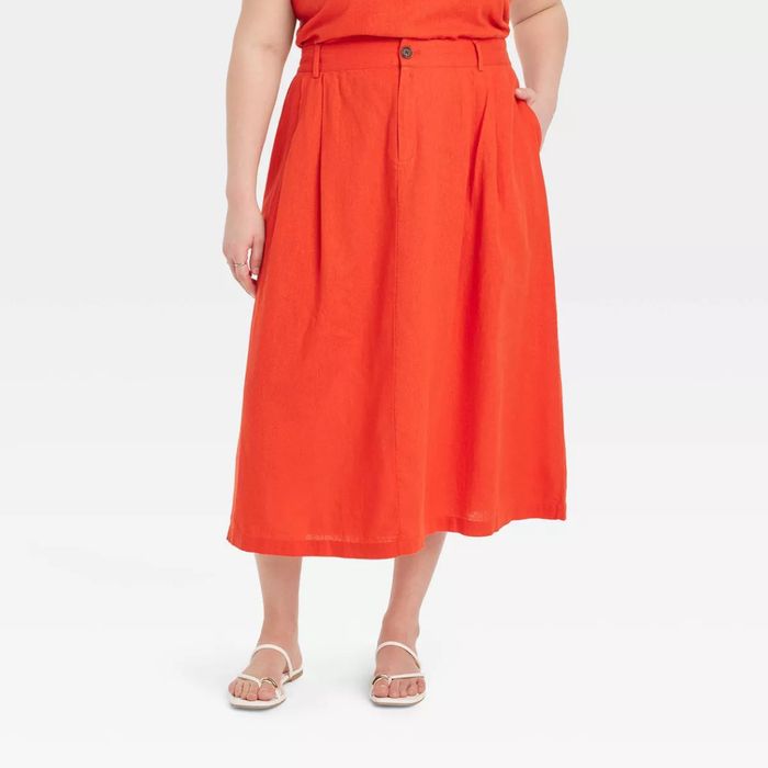 A model showcasing the red skirt.