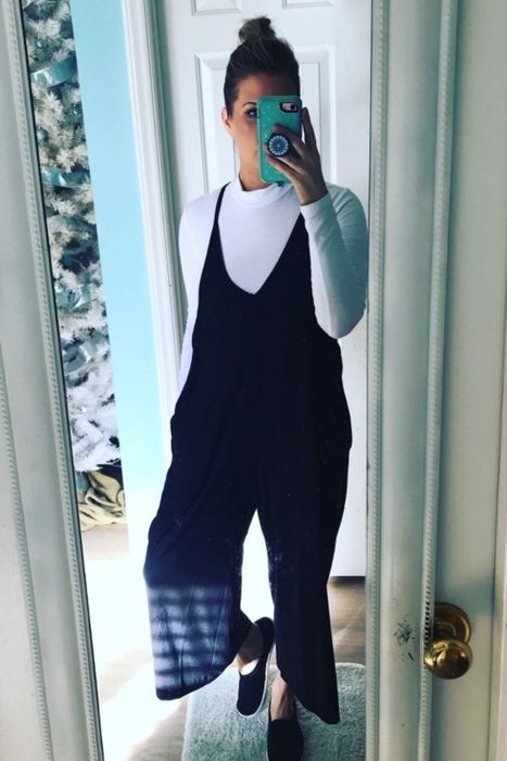 Reviewer rocking the jumper in black with a long-sleeve white shirt underneath