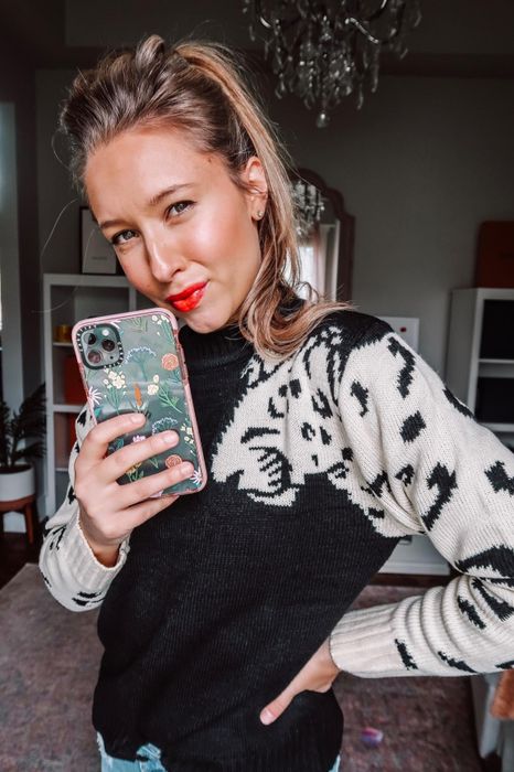 A reviewer wears the sweater in black.