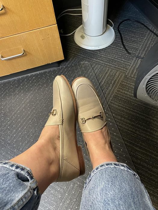 Reviewer sporting light beige loafers, with jeans partially visible