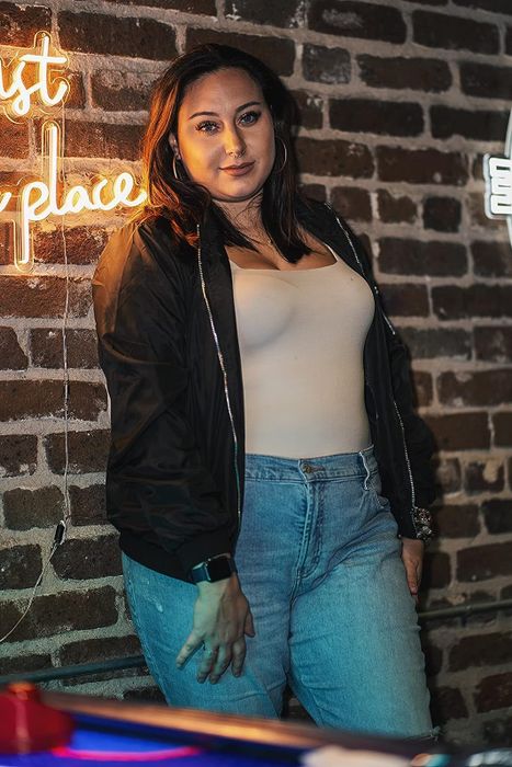 Another reviewer models a sleek black bomber jacket.