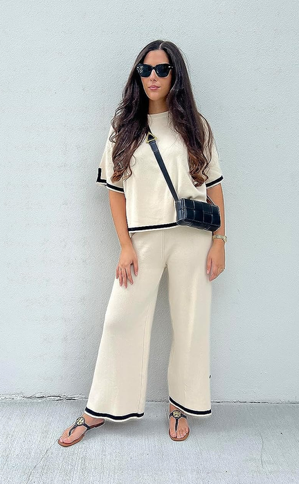 A reviewer showcasing the cream and black set.