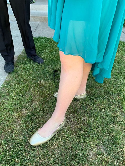 Reviewer styling gold flats with a teal formal dress