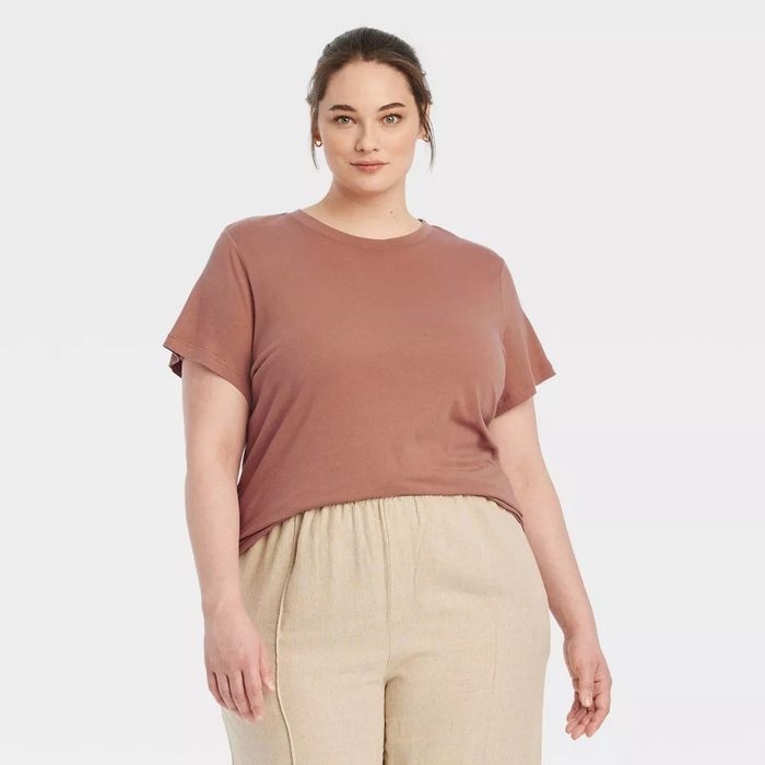 A person wearing a brown t-shirt