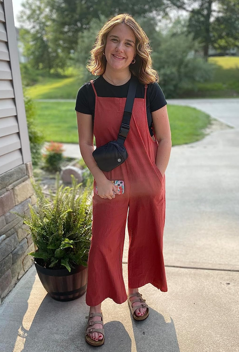 A reviewer in a vibrant red outfit.