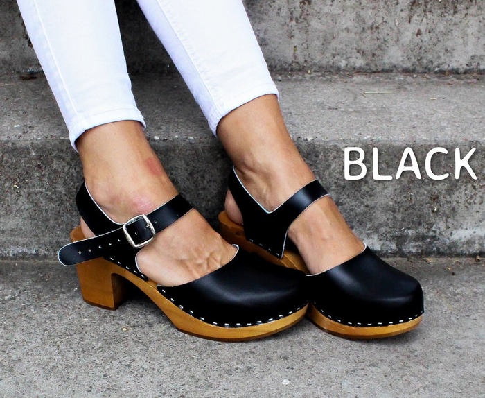 model's feet in black clogs