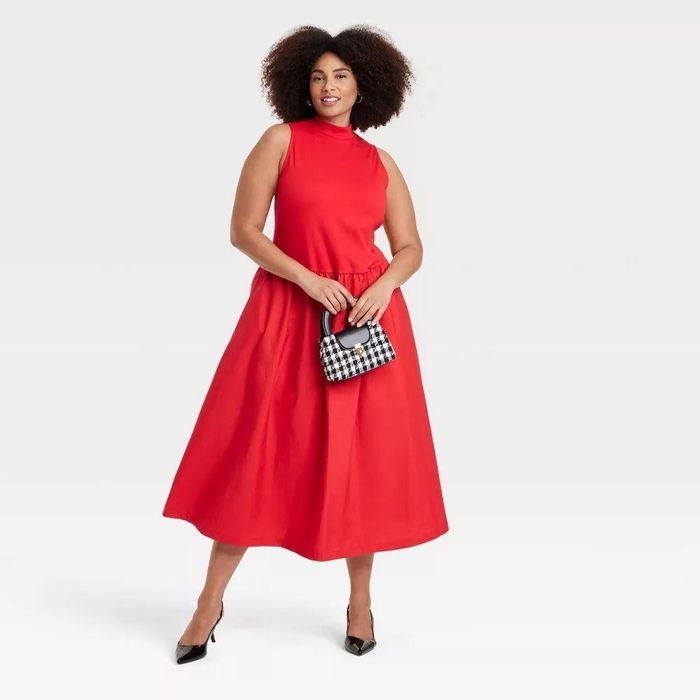 A person in the red version of the dress, looking stylish