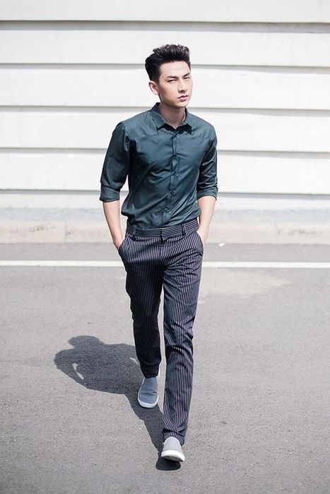 A reviewer showcasing the orange mules in a stylish setting.