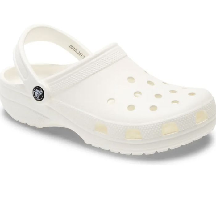 The white Crocs worn by a reviewer.