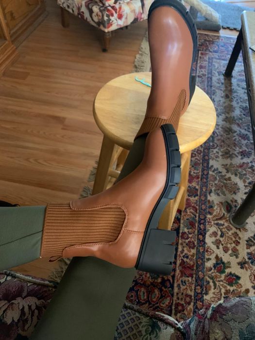 A reviewer showcasing the boots in brown.