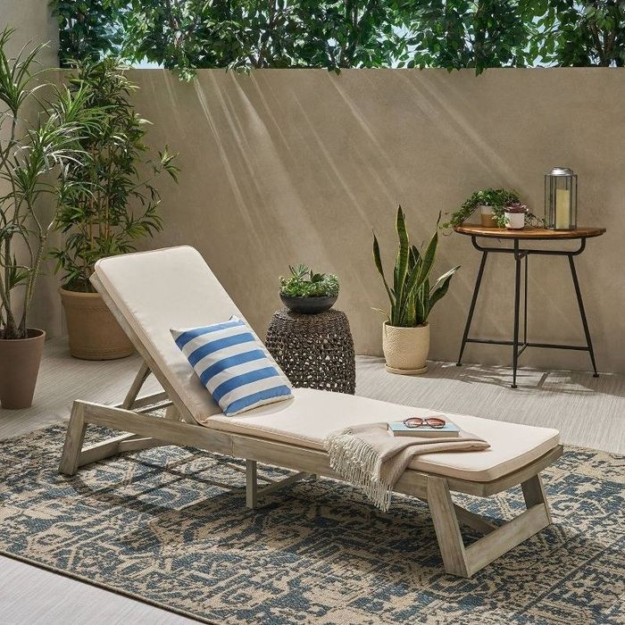 A chaise lounge accented with a cozy pillow, offering both style and relaxation.