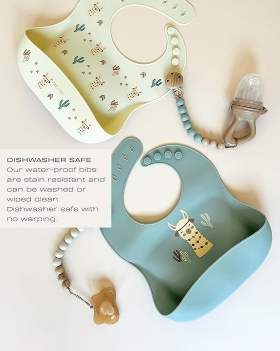 Two waterproof, stain-resistant bibs with desert-themed designs, alongside a pacifier clip and teether. Both are dishwasher safe and easy to clean.